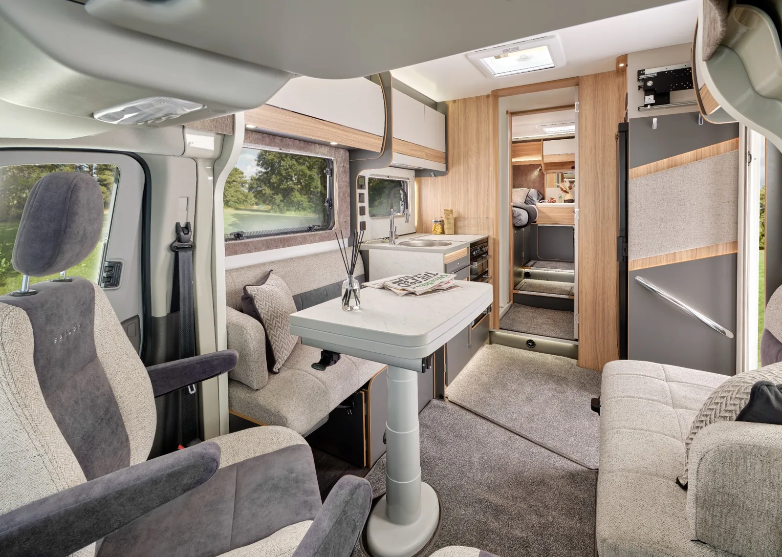 2027 Bailey Adamo 75-4T interior showing lounge kitchen and rear twin bedroom