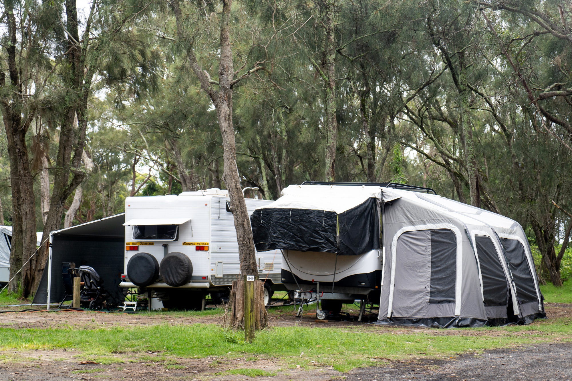 RV Caravans motor homes with awnings at the camping site in the bush. Family camping in Australia